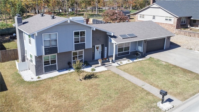 view of front of house with a front lawn and a garage