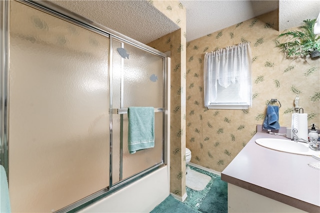 full bathroom featuring vanity, toilet, a textured ceiling, and shower / bath combination with glass door