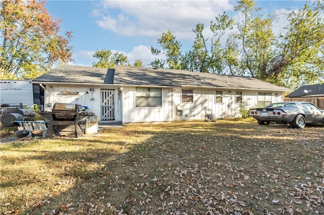 rear view of property featuring a yard