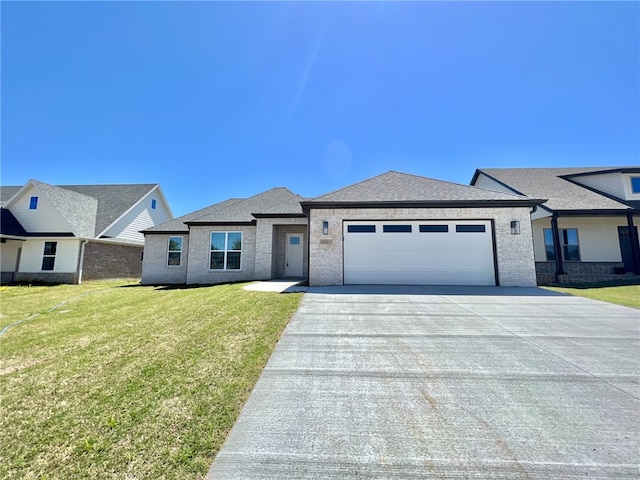 view of front facade with a front yard and a garage