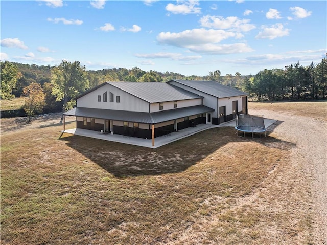 view of front of house featuring a trampoline and metal roof