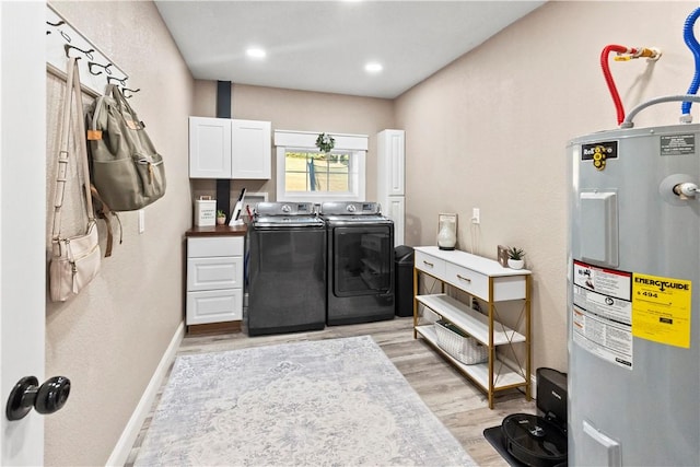 13136 Cedar Grove Rd, Lead Hill, AR 72644 - washroom with cabinet space, baseboards, water heater, separate washer and dryer, and light wood-style flooring