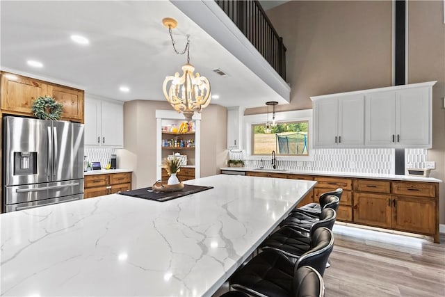 13136 Cedar Grove Rd, Lead Hill, AR 72644 - kitchen with stainless steel refrigerator with ice dispenser, a sink, backsplash, and a chandelier