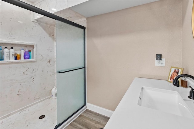 13136 Cedar Grove Rd, Lead Hill, AR 72644 - bathroom with a sink, baseboards, a shower stall, and wood finished floors