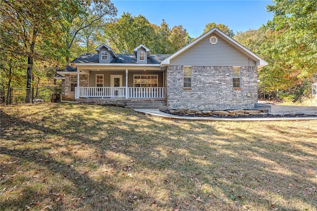 view of front of house with covered porch and a front lawn