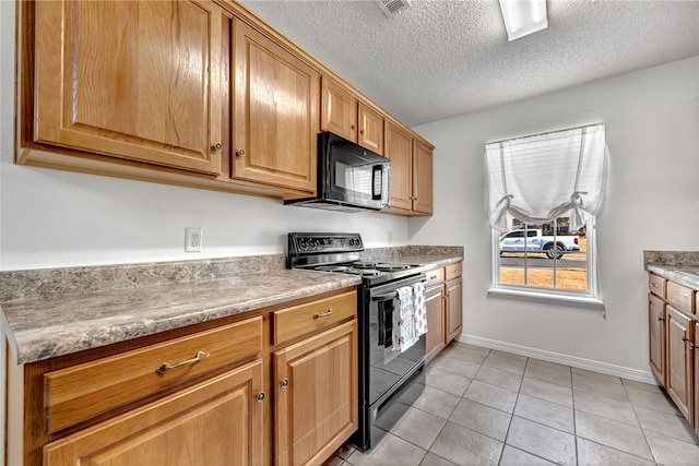 kitchen with light tile patterned flooring, a textured ceiling, light stone countertops, and black appliances