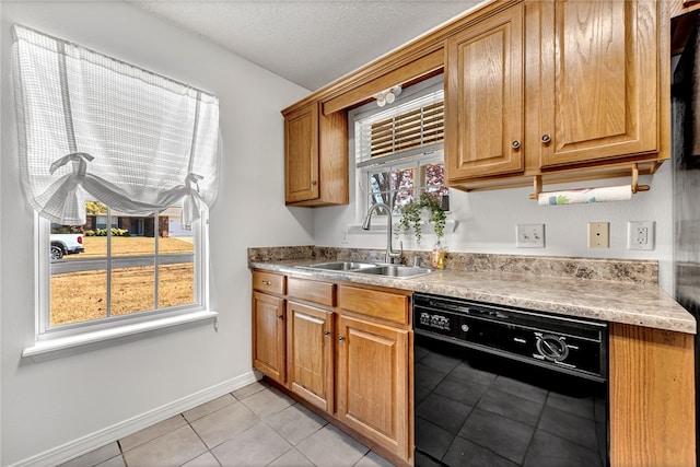 kitchen with black dishwasher, light tile patterned flooring, a textured ceiling, and sink