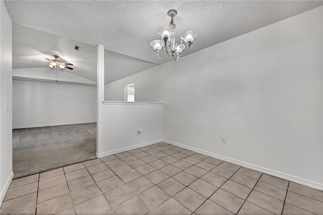 carpeted spare room featuring vaulted ceiling, a textured ceiling, and ceiling fan with notable chandelier