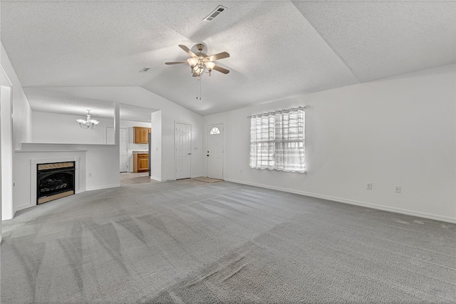 unfurnished living room featuring light colored carpet, a textured ceiling, vaulted ceiling, and ceiling fan with notable chandelier