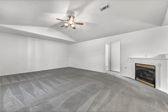 unfurnished living room with lofted ceiling, carpet, a textured ceiling, and ceiling fan