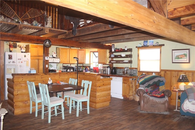 kitchen with beam ceiling, dishwasher, dark hardwood / wood-style floors, and wood walls