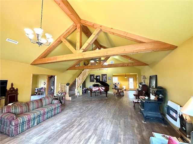 living room with a notable chandelier, visible vents, beam ceiling, wood finished floors, and high vaulted ceiling
