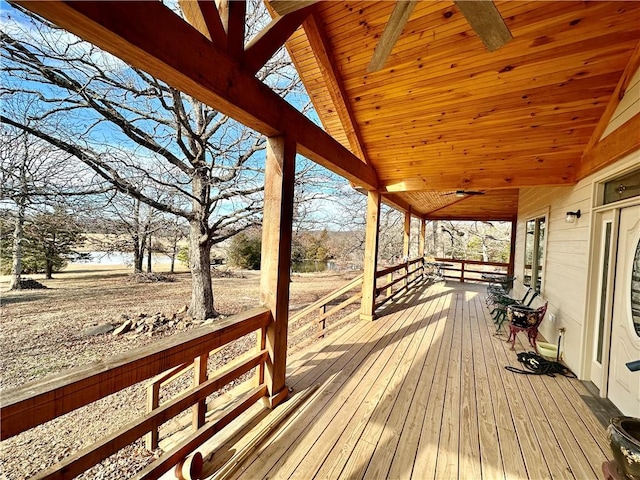 wooden terrace featuring a water view