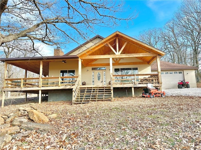 view of front of property with a chimney, stairway, a garage, and a porch