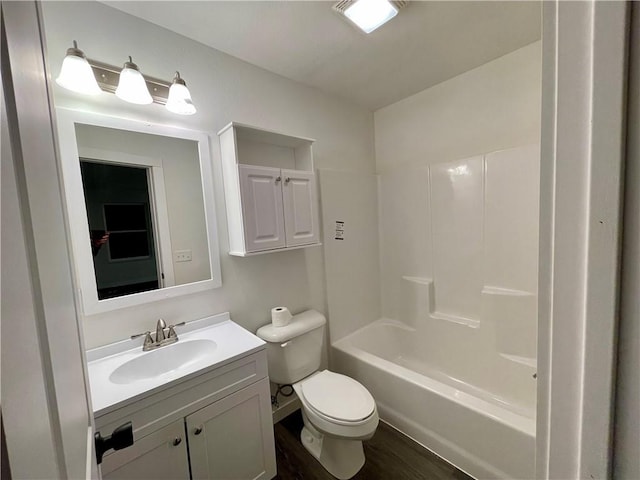 bathroom with toilet, vanity, bathing tub / shower combination, and wood finished floors