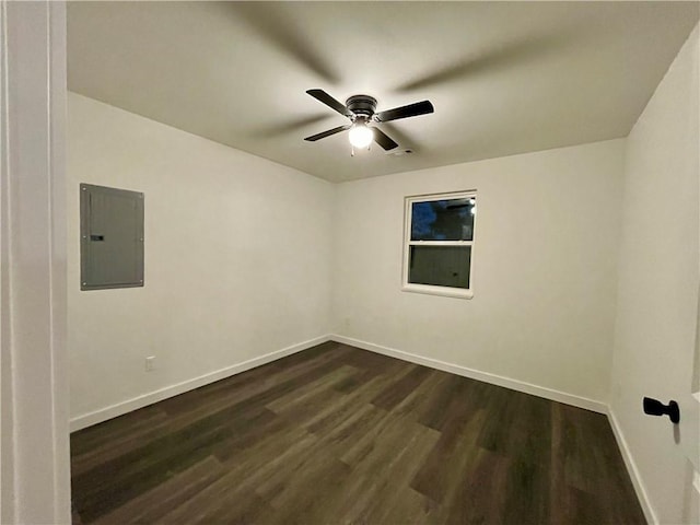 unfurnished room with electric panel, dark wood-style floors, baseboards, and a ceiling fan