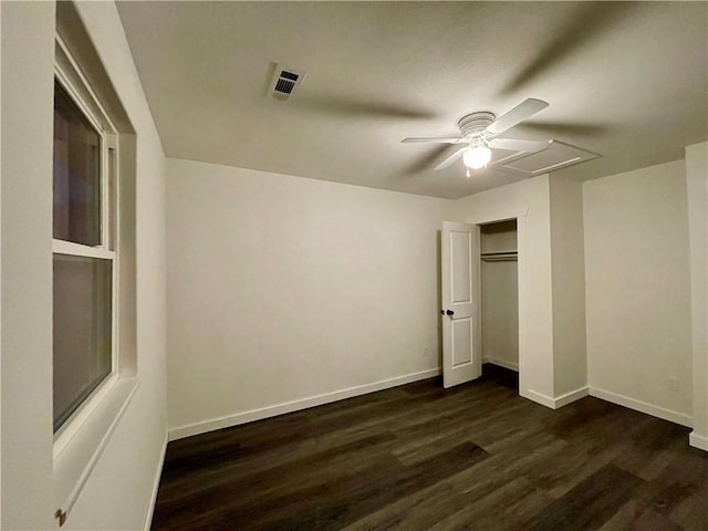 unfurnished bedroom with visible vents, a ceiling fan, dark wood finished floors, a closet, and baseboards