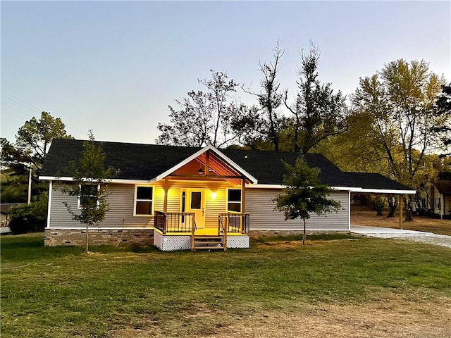 view of front of property with an attached carport, a front lawn, driveway, and crawl space