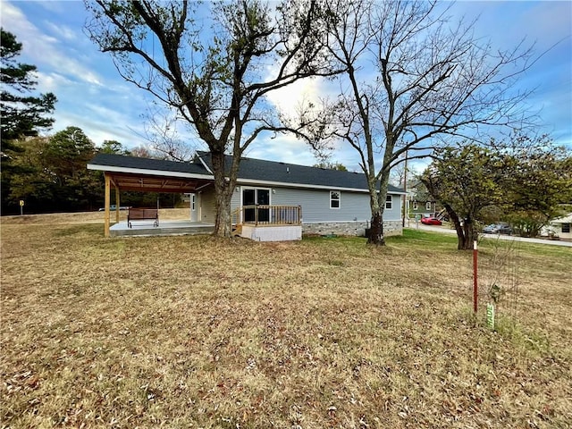 rear view of property featuring a patio and a yard