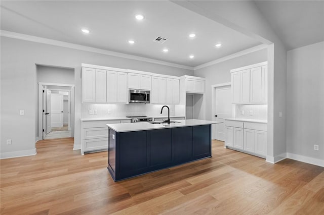 825 Baker St, Pea Ridge, AR 72751 - kitchen featuring stainless steel microwave, crown molding, a sink, light countertops, and backsplash
