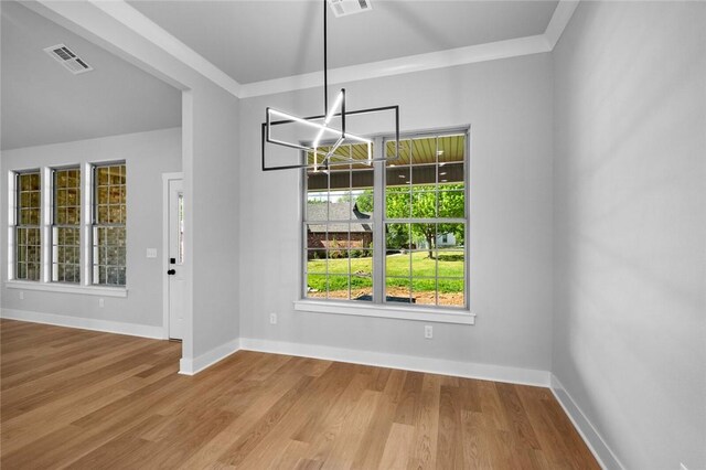 825 Baker St, Pea Ridge, AR 72751 - unfurnished dining area featuring a chandelier, crown molding, visible vents, baseboards, and wood finished floors