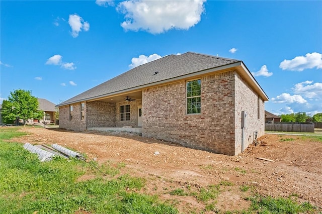 825 Baker St, Pea Ridge, AR 72751 - back of property with a ceiling fan and brick siding