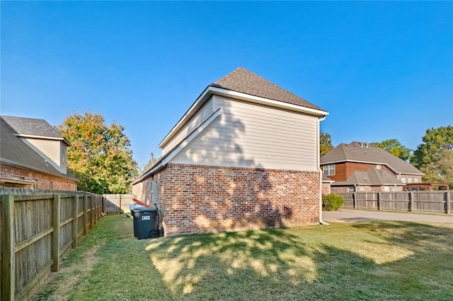 rear view of house featuring a yard