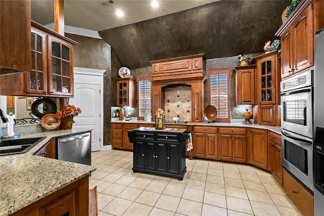 kitchen featuring vaulted ceiling, sink, light tile patterned floors, light stone countertops, and appliances with stainless steel finishes