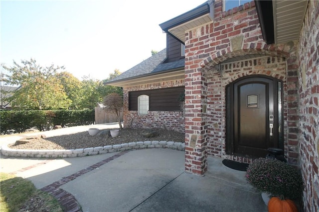 view of exterior entry with a patio