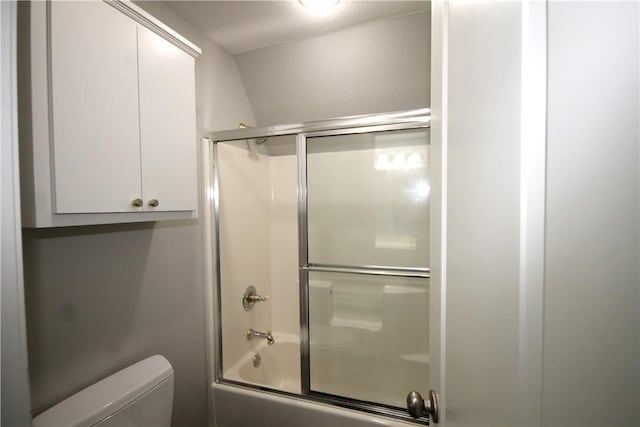 bathroom featuring toilet and enclosed tub / shower combo