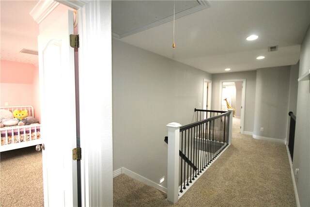 hall featuring carpet flooring and crown molding