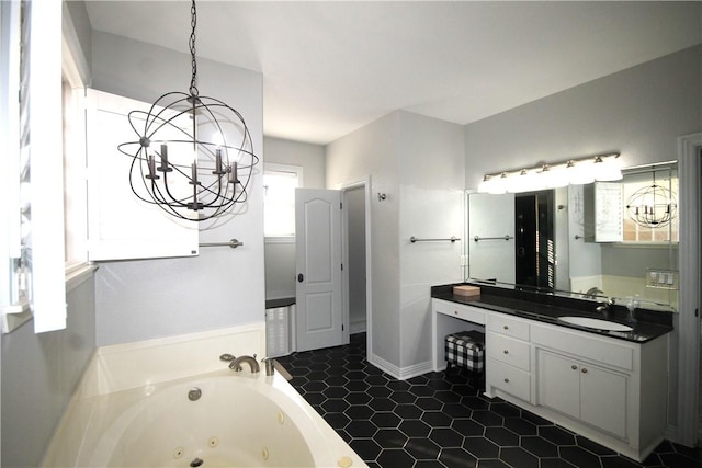 bathroom with a chandelier, a bath, vanity, and tile patterned floors