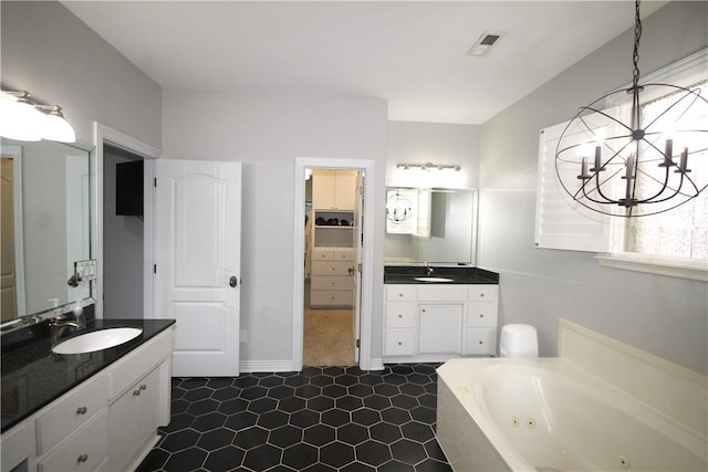 bathroom featuring a bath, tile patterned floors, vanity, and an inviting chandelier