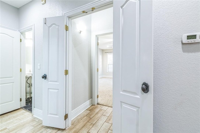 hall with light hardwood / wood-style floors