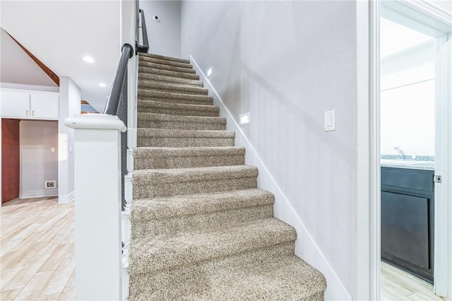 stairs featuring hardwood / wood-style flooring