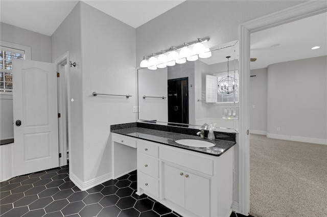 bathroom with vanity and an inviting chandelier