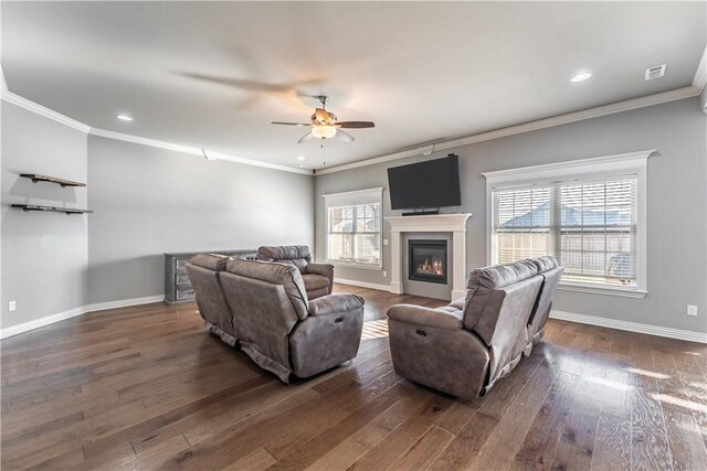 living room featuring crown molding, dark wood-type flooring, and ceiling fan