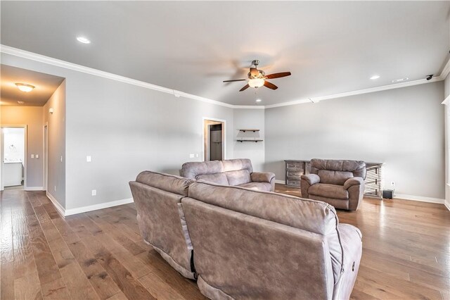 living room featuring crown molding, ceiling fan, and light hardwood / wood-style flooring