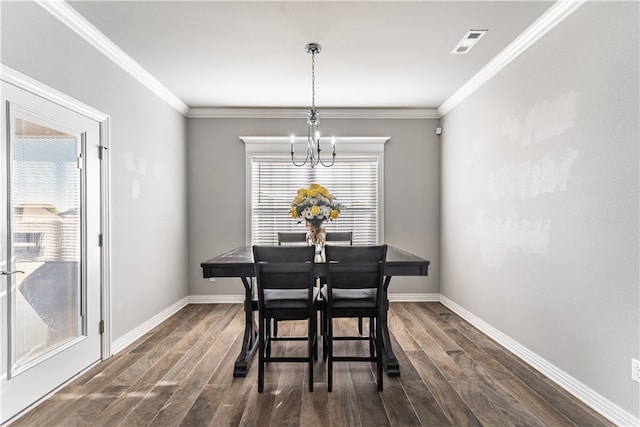 dining room featuring crown molding, plenty of natural light, and a notable chandelier