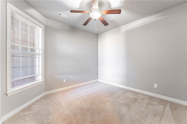 carpeted empty room featuring ceiling fan