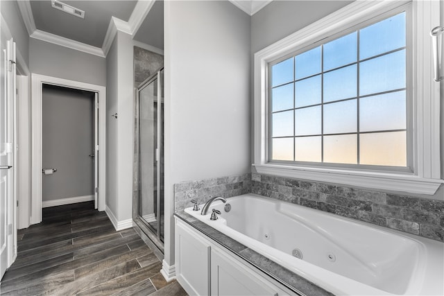 bathroom with crown molding and separate shower and tub