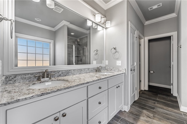 bathroom with vanity, ornamental molding, and walk in shower