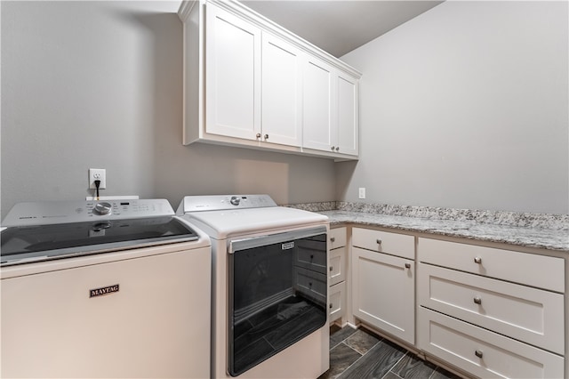 laundry room with cabinets and washing machine and clothes dryer