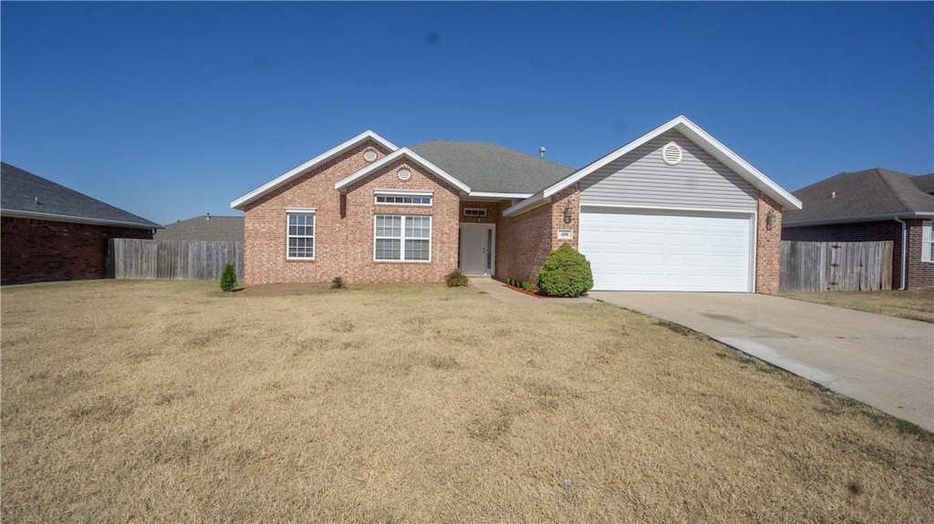 single story home with a front yard and a garage