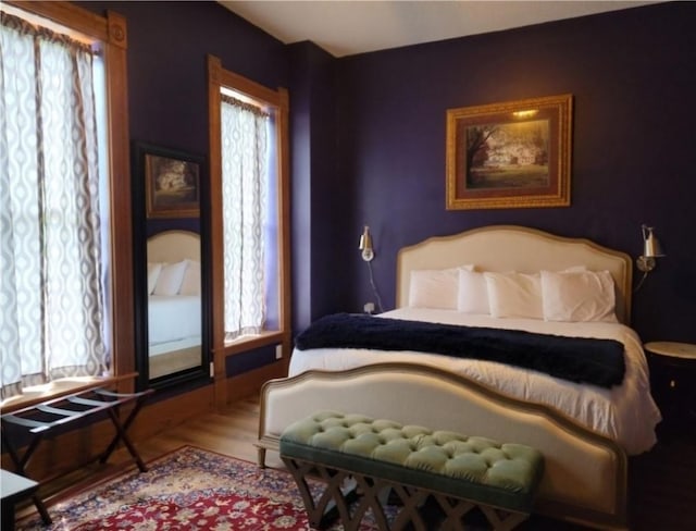 bedroom featuring multiple windows and wood-type flooring