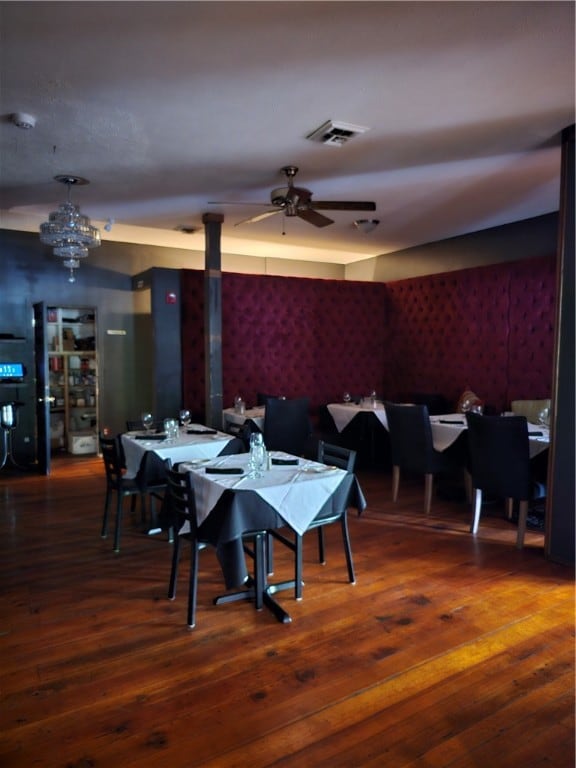 dining room featuring wood-type flooring and ceiling fan