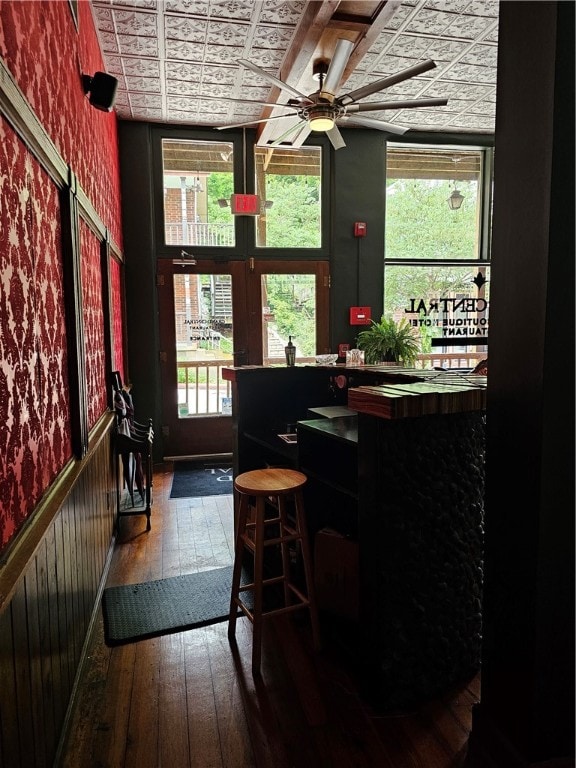 interior space with ceiling fan, wood-type flooring, and plenty of natural light