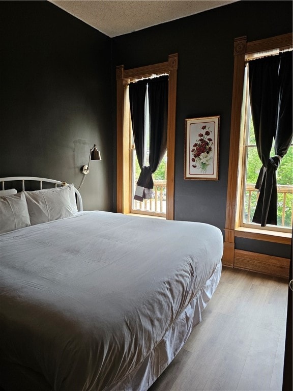 bedroom featuring light hardwood / wood-style flooring and a textured ceiling