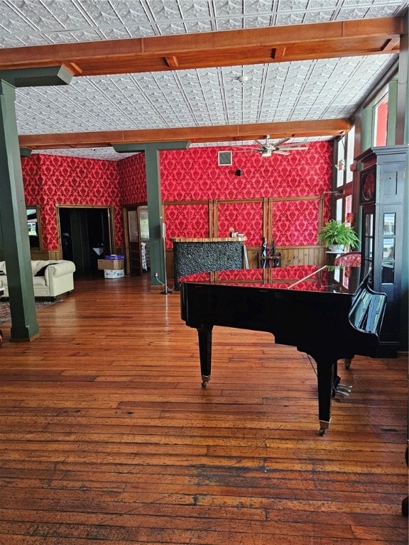 game room featuring vaulted ceiling with beams and wood-type flooring