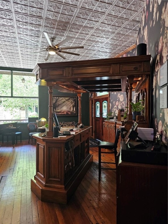 office area featuring wood-type flooring, ornate columns, and ceiling fan